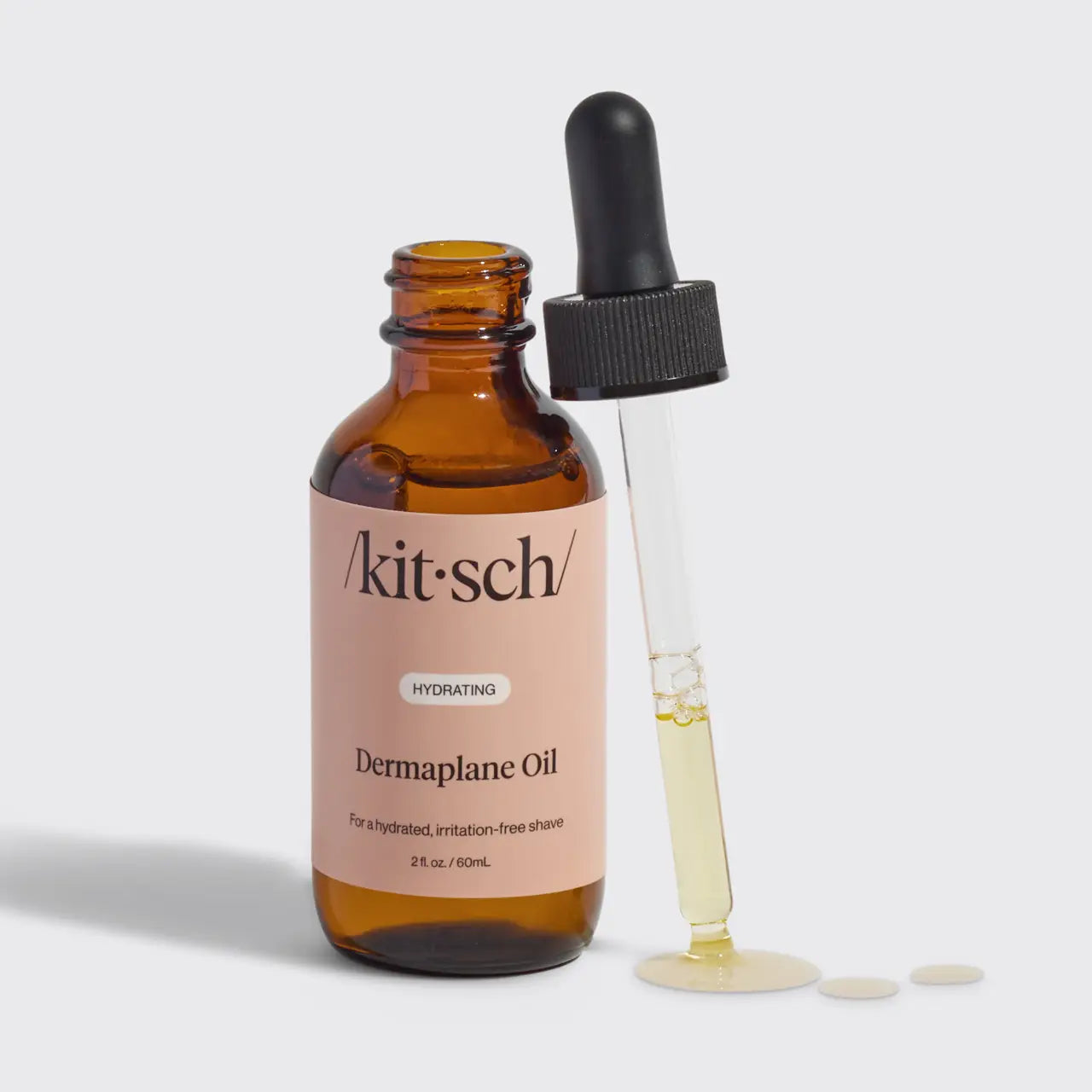 Brown bottle with dropper labeled 'kitsch' on a light gray background