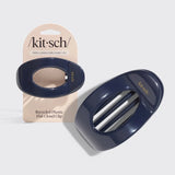 A glossy dark navy blue flat cloud clip shown next to its beige retail card packaging. The packaging features the brand name 'kit-sch' and text reading 'Thick, Long & Curly Hair | 1/2"' from Nespoli Jewelers