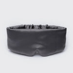 Black sleep mask on a light gray background