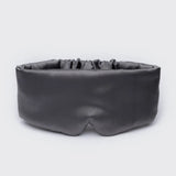 Black sleep mask on a light gray background