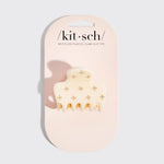 A cream-colored recycled plastic claw clip with small gold floral accents, presented on a light pink branded card backing. The brand name 'kit-sch' is printed at the top.