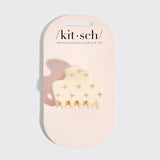 A cream-colored recycled plastic claw clip with small gold floral accents, presented on a light pink branded card backing. The brand name 'kit-sch' is printed at the top.