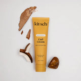 Kitsch Moisturizing Curl Cream tube with coconut pieces on a light gray background
