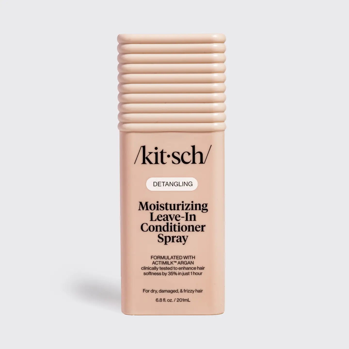 A bottle of Kitsch Detangling Moisturizing Leave-in Conditioner Spray in a light peach-beige color, shown on a light gray background.
