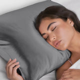 Woman sleeping with a gray pillow on a white background