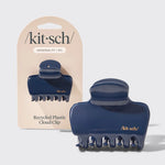 Blue hair clip with 'kit-sch' branding on a beige card against a white background