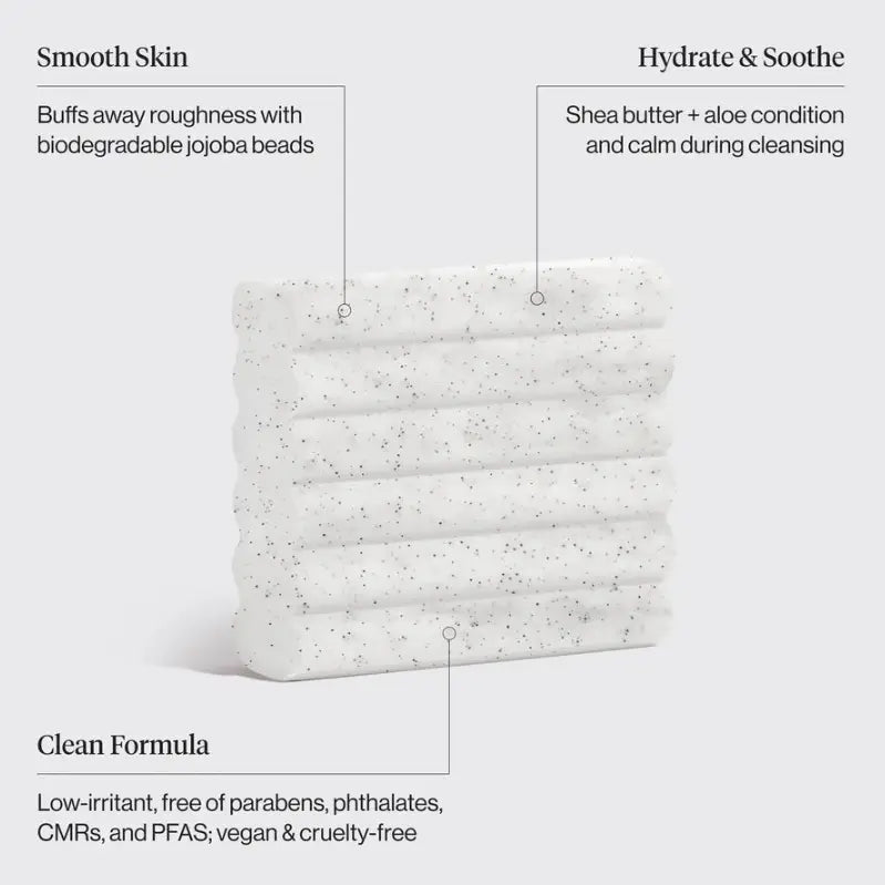 A white textured cleansing bar with black speckles, shown on a light gray background with callout text describing its benefits: Smooth Skin, Hydrate & Soothe, and Clean Formula.