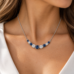 Woman wearing a Zeghani 14K white gold necklace featuring alternating blue sapphires and diamonds.