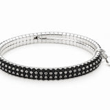 Lizas Hanson Jet Bracelet features shimmering jet black accents with a polished silver-tone finish in a comfortable multi-row flexible bangle design.
