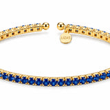 Lizas Denver Azure Bracelet with blue stones and a polished gold finish on a white background.