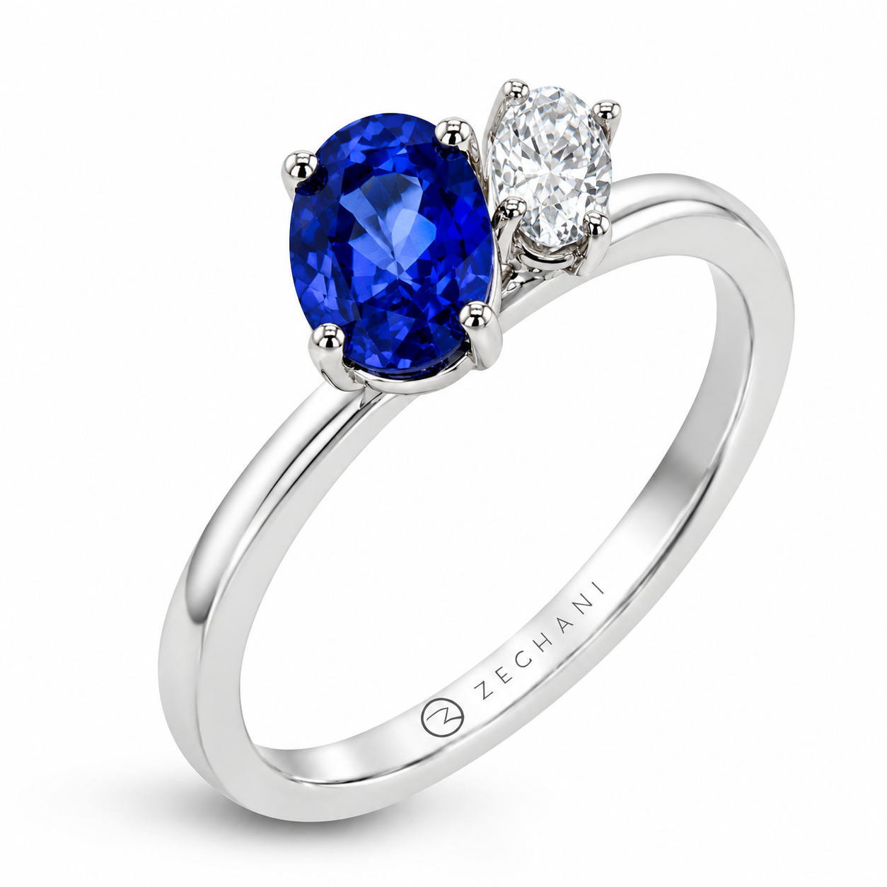 Zeghani white gold two-stone ring featuring an oval blue sapphire and oval diamond in a polished setting.