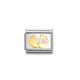 Gold and silver charm with baby feet and a heart on a white background