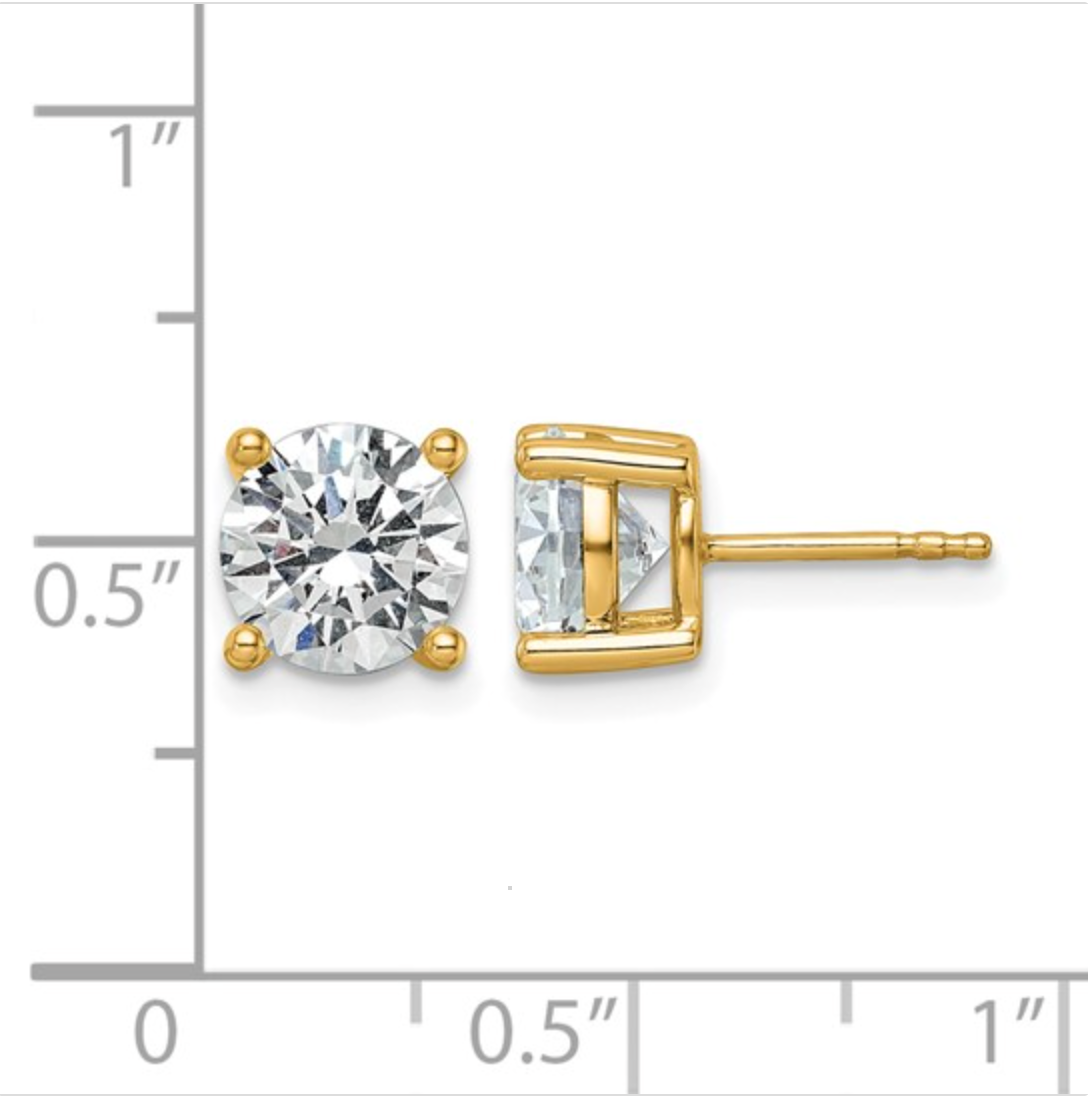 Gold stud earrings with clear gemstones on a white background with measurement scale.