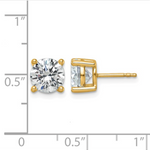 Gold stud earrings with clear gemstones on a white background with measurement scale.