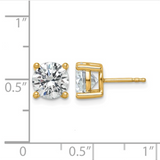 Gold stud earrings with clear gemstones on a white background with measurement scale.