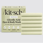 Kit Sch Resurfacing Glycolic Acid Face & Body Wash shown with its beige box and two pale yellow-green soap bars on a light gray background.
