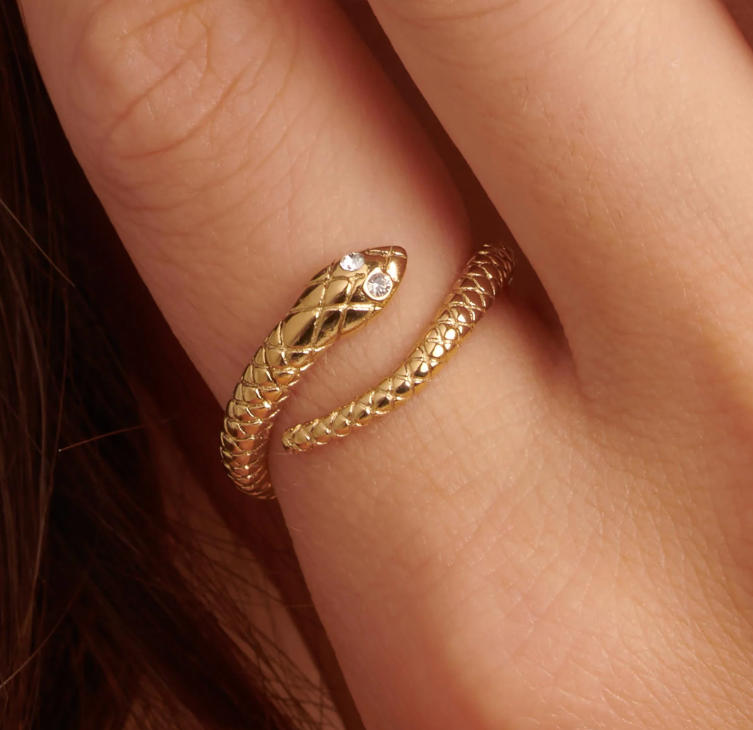 Brosway CHAKRA Mystic gold snake ring with clear crystal eyes worn on a finger.