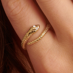 Brosway CHAKRA Mystic gold snake ring with clear crystal eyes worn on a finger.