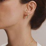 FYB Jewelry Sondra gold cubic zirconia stud earrings worn in a layered ear look