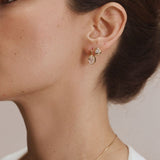 FYB Jewelry Sondra gold cubic zirconia stud earrings worn in a layered ear look