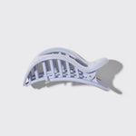 White hair clip on a light gray background