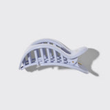 White hair clip on a light gray background