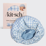 A light blue and white gingham satin-lined flexi bonnet shown in front of its pink packaging box on a light gray background.