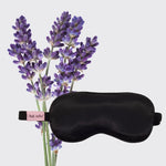 Black sleep mask with lavender flowers on a light gray background