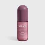 A bottle of kit-sch Soft Santal hair perfume, featuring a dusty purple cap and a metallic mauve-pink bottle with white text, set against a light gray background.