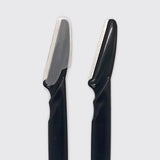 Two black grooming razors with silver metal blades, shown side-by-side against a light gray background.