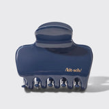 Blue hair clip with 'kit-sch' branding on a light gray background