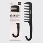 Black wide-tooth comb with packaging on a light gray background