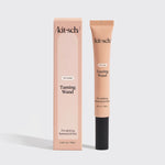 A Kitsch Taming Wand styling product shown as a peach-colored squeeze tube next to its matching peach-colored box on a light gray background.
